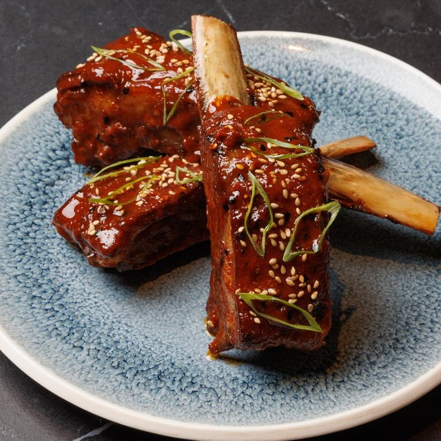 Savor each bite of our heavenly lamb ribs coated with …